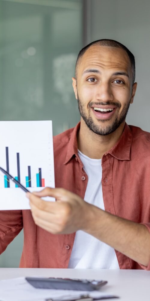 Successful man with report showing colleagues and partners successful results of escaping unpredictable revenue.